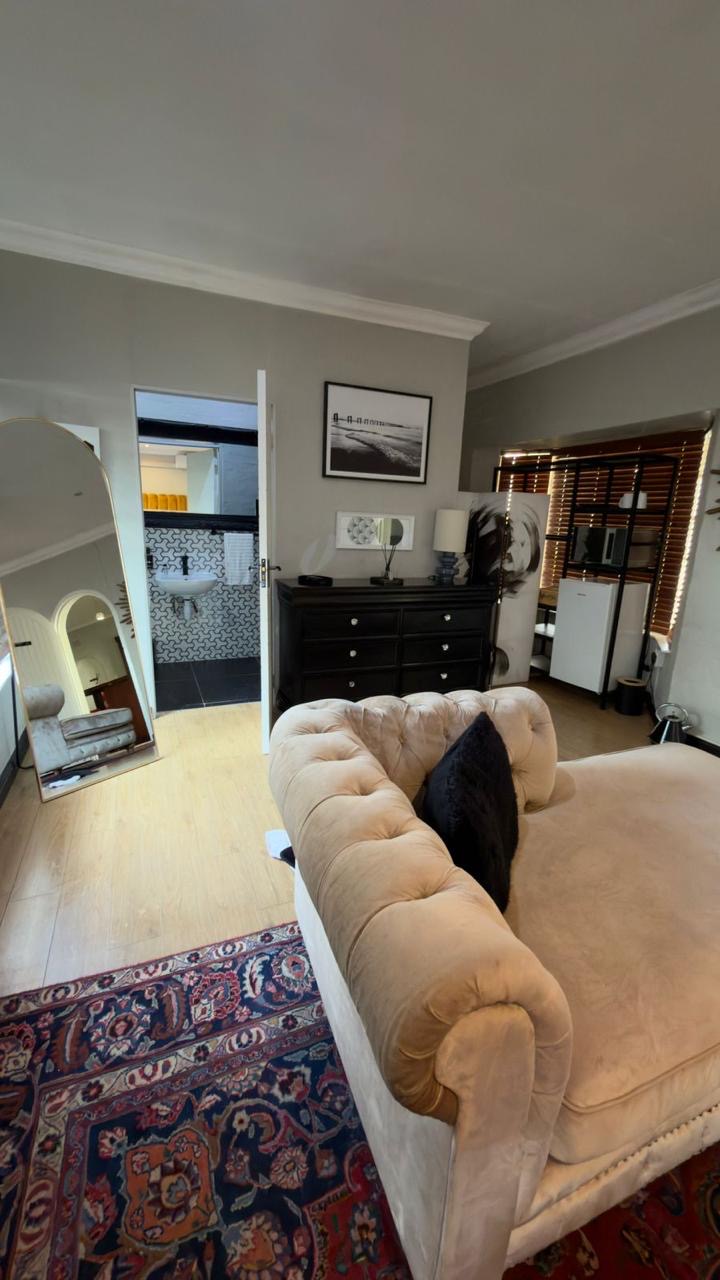 Room 9 chaise lounge with bathroom and dressing area in view