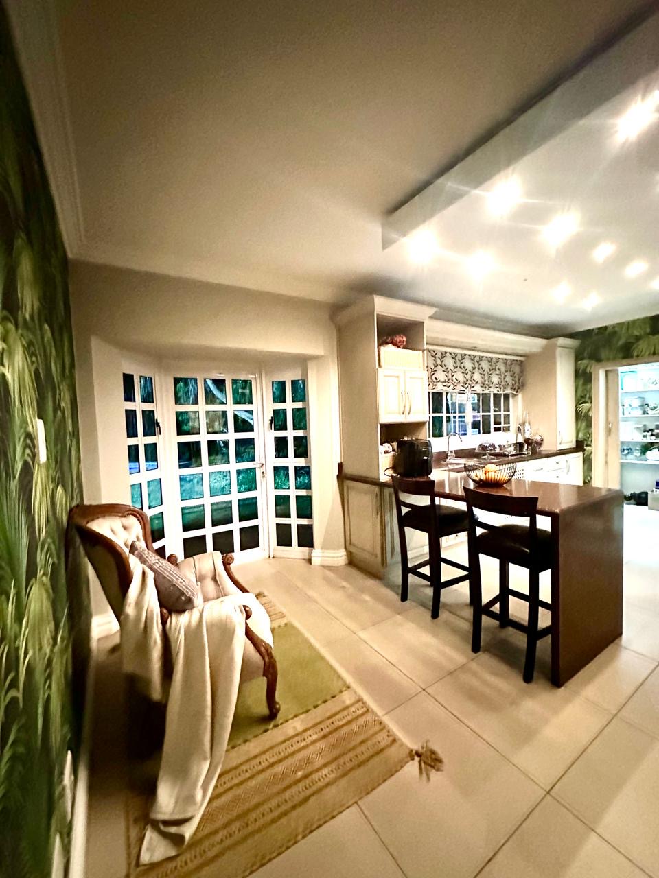 Bright breakfast and dining area with French doors at Cherry Nest