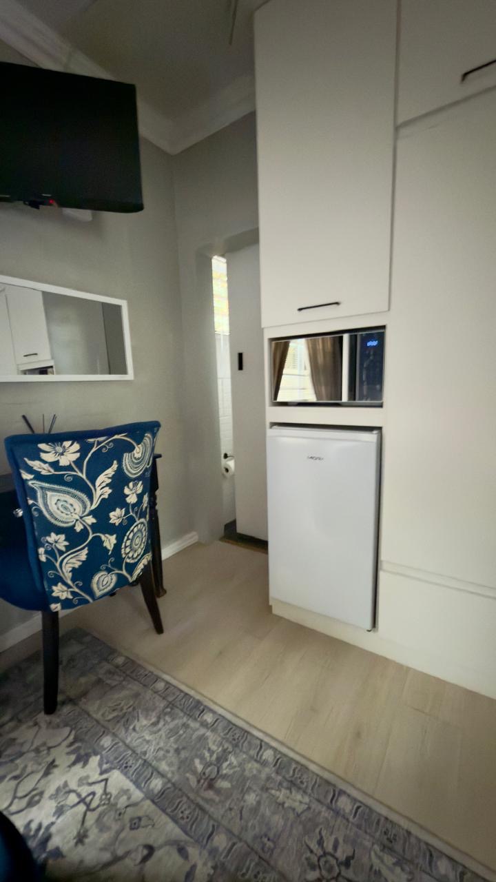 Room 8 bar fridge, microwave and wall-mounted TV