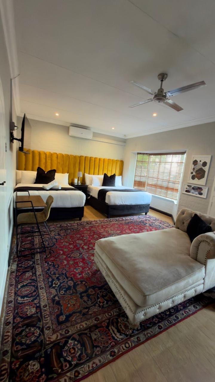 Room 9 family room with two queen beds and chaise lounge at Cherry Nest