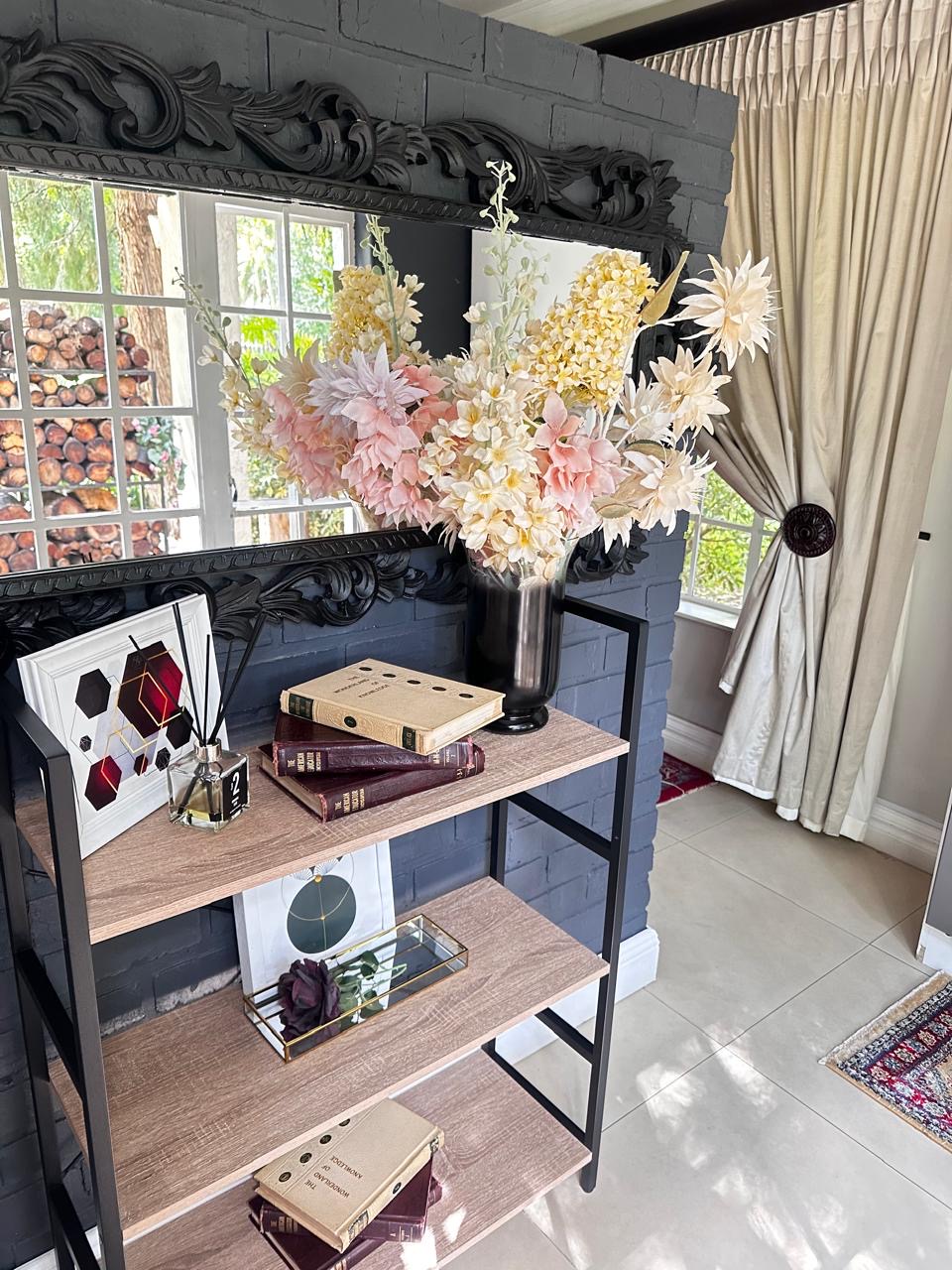Room 1 styled shelf with flowers, books and decor