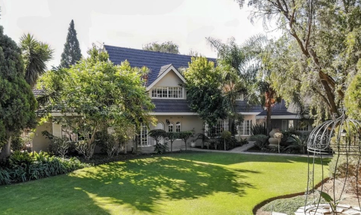 Cherry Nest guesthouse exterior with landscaped lawn and mature garden