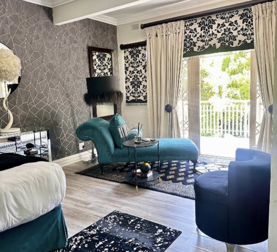 King room with balcony and lounge seating at Cherry Nest