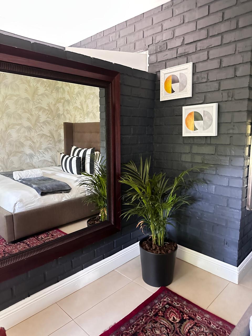 Room 1 full-length mirror and feature wall
