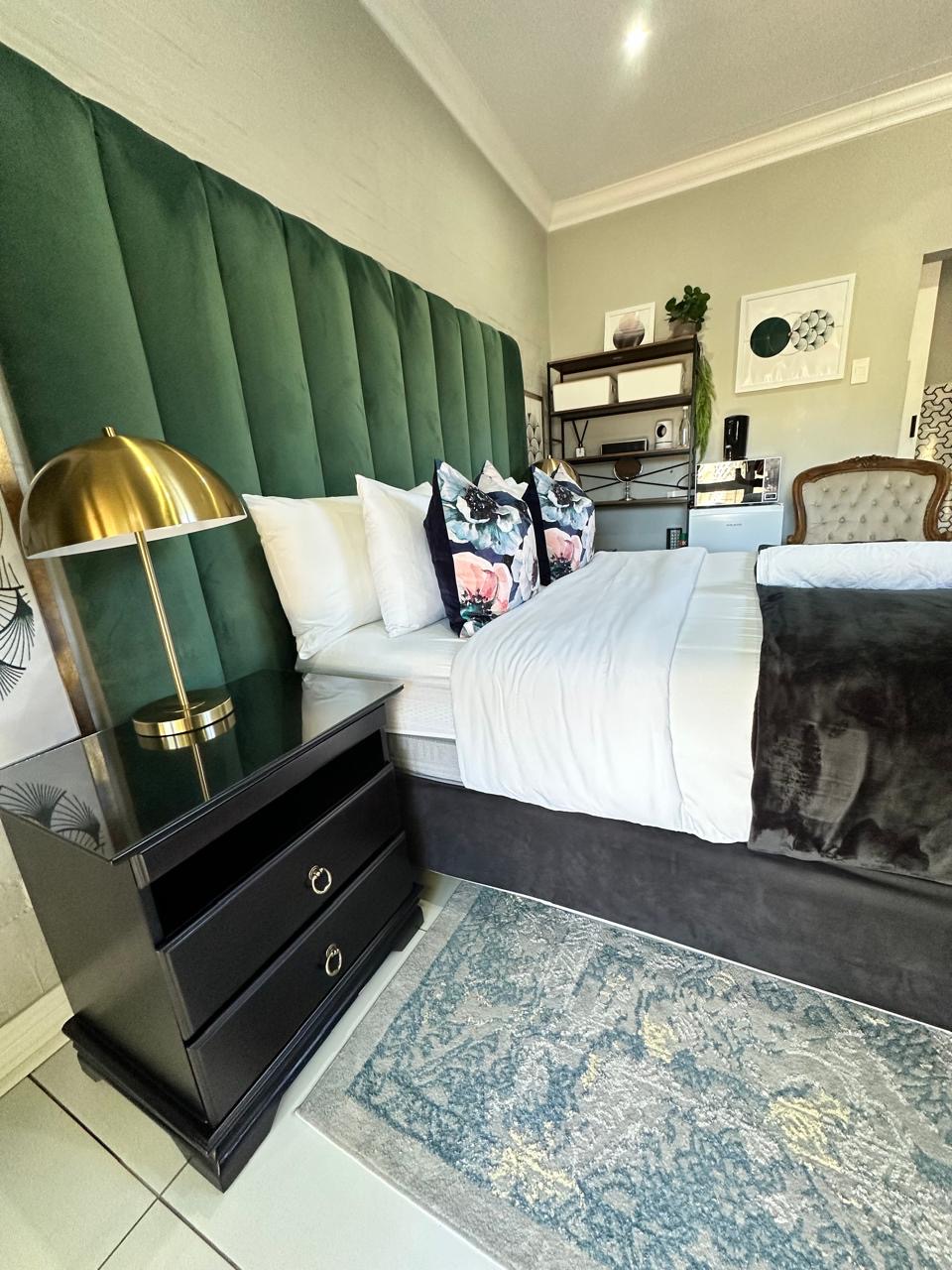Room 10 standard queen room with green headboard at Cherry Nest