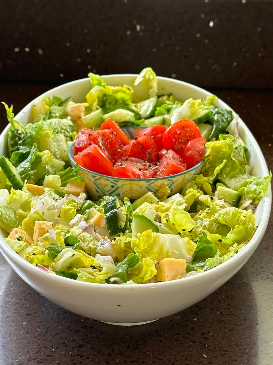 Fresh green salad with cucumber, tomato and cheese