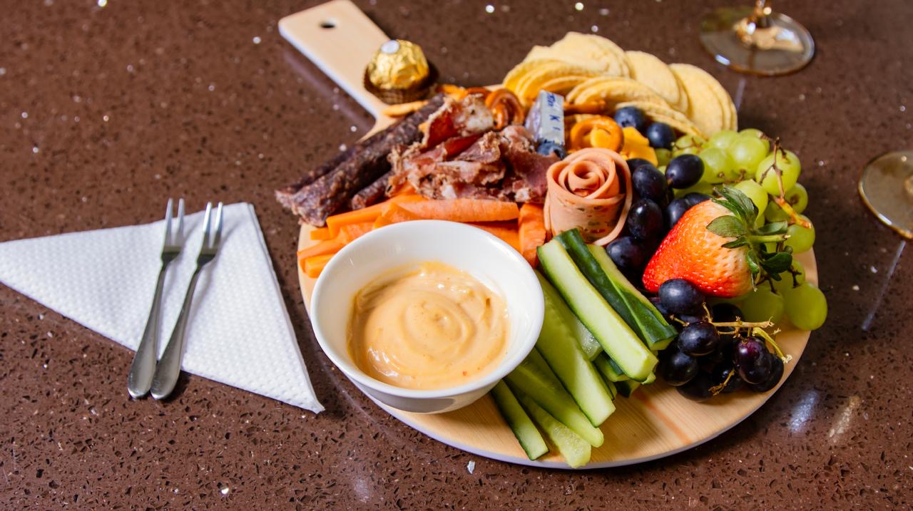 Breakfast platter with fruit, cured meats, cheese and preserves